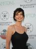 Alana De La Garza in a black dress