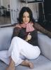 Alizee sitting on a sofa