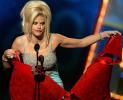 Anna Nicole Smith holding an enourmous red bra