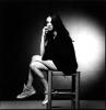 Asia Argento Sitting on a Bench