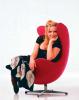 Brett posing in a red chair
