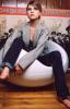 Clemence Poesy sitting on a white chair