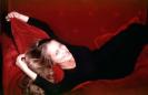 Estelle Skornik lying on red sofa